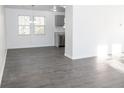 Spacious dining area with gray vinyl plank flooring and modern light fixture at 2655 Brandenberry Dr, Decatur, GA 30034