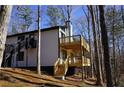 Modern home with two-tiered deck and wooded views at 6076 Belle Meade Dr, Villa Rica, GA 30180