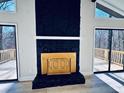 Living room with a stone fireplace and access to a deck at 6076 Belle Meade Dr, Villa Rica, GA 30180