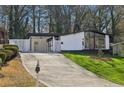 Charming ranch home with updated facade and spacious driveway at 2592 Baker Nw Rd, Atlanta, GA 30318