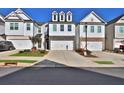 New construction townhouse with symmetrical design and attached garages in a modern community at 257 Whitetail Cir, Canton, GA 30115