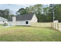 Spacious backyard with a new wooden fence and partial lush grass area at 4541 Old Highway 138 Sw, Loganville, GA 30052