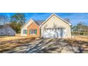 Ranch-style home with a wide driveway and a two-car garage at 4541 Old Highway 138 Sw, Loganville, GA 30052
