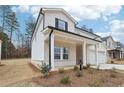 Attractive two-story home featuring a covered porch with brick and white siding in a suburban neighborhood at 291 Martin Spring Rd, Lawrenceville, GA 30045