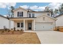 Beautiful two-story home with a two-car garage, covered porch and a combination of brick and siding at 291 Martin Spring Rd, Lawrenceville, GA 30045