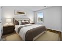 Serene bedroom with a tufted headboard bed, neutral tones, and natural light from a window at 819 Major Oak Ct, Villa Rica, GA 30180