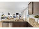 Open-concept kitchen with granite counters and a view of the living area with a cozy fireplace at 819 Major Oak Ct, Villa Rica, GA 30180