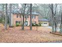 Two-story brick home with mature trees and a two-car garage at 1920 Shoreline Trce, Grayson, GA 30017