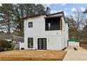 Contemporary two-story home with a balcony, well-kept yard, and modern appeal at 2208 Baker Nw Rd, Atlanta, GA 30318