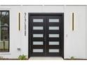 Modern front door with glass panels and stylish lighting fixtures on a white home exterior at 2208 Baker Nw Rd, Atlanta, GA 30318