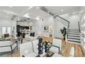 Bright, open-concept living room with modern furnishings and staircase at 2208 Baker Nw Rd, Atlanta, GA 30318