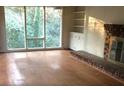 Bright living room featuring a brick fireplace, built-in shelving, and large windows at 138 Le Brun Ne Rd, Atlanta, GA 30342