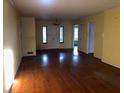 Open-concept living room featuring wood floors and natural light from windows flanking the front door at 138 Le Brun Ne Rd, Atlanta, GA 30342