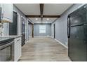 Open concept kitchen with exposed beams and modern flooring at 4598 Flint Hill Rd, Austell, GA 30106
