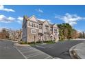 Charming townhome community with landscaped common areas and a view of the surrounding neighborhood on a sunny day at 100 Marietta Walk Trce, Marietta, GA 30064