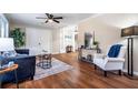 Spacious living room featuring hardwood floors, a ceiling fan, and ample seating at 516 Richards Rd, White, GA 30184