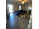 Open living area with sectional sofa and wood-look floors at 534 Hamilton E Holmes Dr, Atlanta, GA 30318