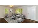 Living room with gray sectional sofa and hardwood floors at 2076 W Flat Shoals Ter, Decatur, GA 30034