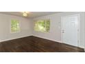 Living room featuring hardwood floors and large windows at 2076 W Flat Shoals Ter, Decatur, GA 30034