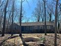 Charming single-story home with a stone foundation and mature trees in a peaceful setting at 4345 Wellington Pl, Cumming, GA 30040