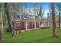 Brick home with a long porch, nestled among trees at 3404 Mount Olive Rd, Atlanta, GA 30344