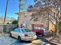 Rear view of the home with a detached garage and a brick exterior at 3928 Potomac Nw Dr, Kennesaw, GA 30144