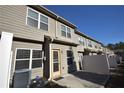 Townhome rear elevation, showcasing a private patio and fenced-in backyard at 7765 Haynes Park Cir, Lithonia, GA 30038