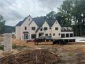 Spacious new construction home featuring light brick facade, modern design, and construction equipment at 839 Braselton Hwy, Lawrenceville, GA 30043