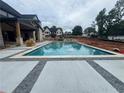 Inviting backyard features a large pool, spa, and patio area with pavers at 839 Braselton Hwy, Lawrenceville, GA 30043