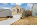 Two-story house with brick and siding, two-car garage, and landscaping at 518 Firethorn Ct, Villa Rica, GA 30180