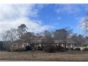 Lovely brick home with a welcoming facade and established landscaping at 3557 Clubhouse Ln, Conyers, GA 30094