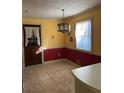 Eat-in kitchen with tile floors, wainscoting, and decorative lighting fixture at 3557 Clubhouse Ln, Conyers, GA 30094