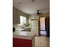 Traditional kitchen with white appliances, tile flooring and lots of cabinet space at 3557 Clubhouse Ln, Conyers, GA 30094