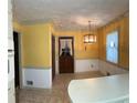 Kitchen featuring tile floors, light fixture, and white cabinets and countertops at 3557 Clubhouse Ln, Conyers, GA 30094