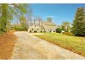 Two story house with long driveway and mature trees at 3937 Ashford Dunwoody Ne Rd, Brookhaven, GA 30319