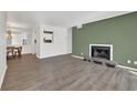 Bright living room featuring a fireplace and new flooring with views into the dining area and kitchen at 2707 Country Park Se Dr, Smyrna, GA 30080