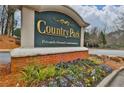Elegant Country Park condominiums sign with lush flower bed, a prestigious and privately owned community at 2707 Country Park Se Dr, Smyrna, GA 30080