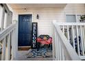 Inviting front porch with welcome sign, a chair, and decor, creating a warm and hospitable entryway to the home at 706 Berry Ct, Villa Rica, GA 30180