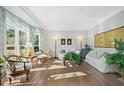 Spacious living room with hardwood floors, large windows, and comfortable furniture at 125 Hillcrest Trce, Fayetteville, GA 30215