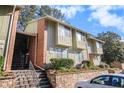 Front view of a townhome building with stairs and landscaping at 2220 Runnymead Se Rdg, Marietta, GA 30067