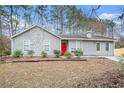 Gray house with red door and stone accents at 5632 Rock Springs Rd, Lithonia, GA 30038