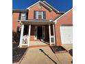 Home exterior showcasing the well-maintained front porch and attached two car garage at 575 Dunagan Dr, Lawrenceville, GA 30045