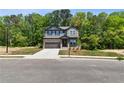 Charming two-story home featuring stone and siding exterior, manicured lawn and attached two-car garage at 4002 Adler Cir, Buford, GA 30519