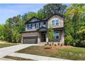 Charming two-story home featuring stone and siding exterior, manicured lawn and attached two-car garage at 4002 Adler Cir, Buford, GA 30519