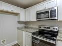 Updated kitchen boasts granite countertops and stainless steel appliances at 905 Fairburn Nw Rd, Atlanta, GA 30331