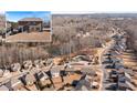 Community overview showcasing houses, lake, and surrounding landscape at 5915 Partners Pass, Cumming, GA 30028