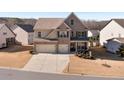 Two-story brick home with a three-car garage and manicured lawn at 5915 Partners Pass, Cumming, GA 30028