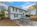 Gray two-story house with a driveway and landscaping at 2098 Mallard Crst, Lithonia, GA 30058