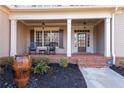 Inviting front porch with rocking chairs and brick flooring at 221 Oakwood Dr, Cumming, GA 30040