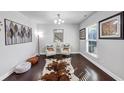 Bright, minimalist living room boasting hardwood floors, and stylish seating arrangement near the window at 4349 Northmark Ln, Buford, GA 30518